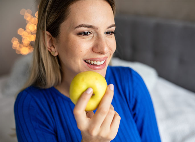 Woman eating apple