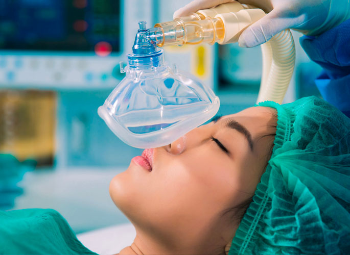 Woman undergoing dental procedure under general anesthesia