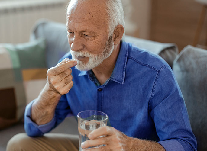 Man taking oral medication