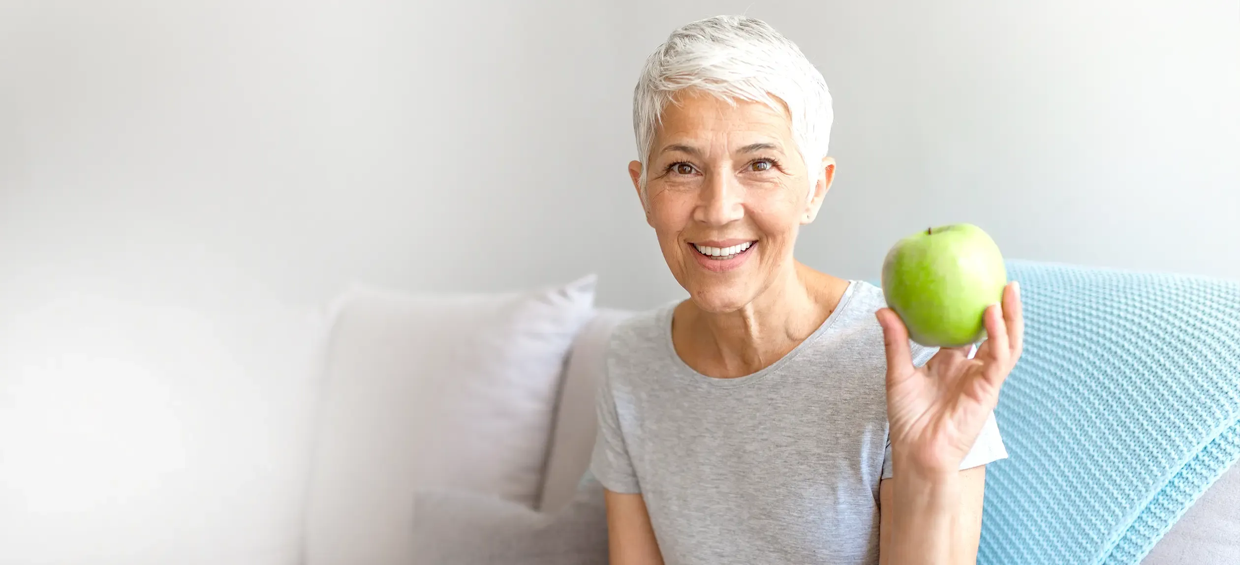 Woman holding a green apple